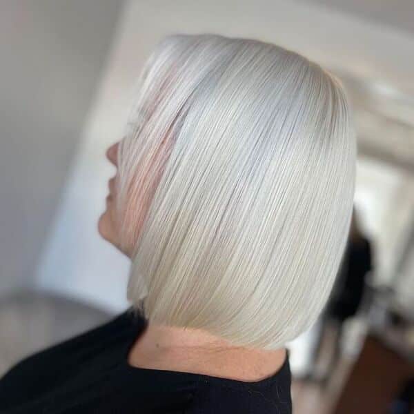 Platinum White Ash Blonde - a woman wearing a black shirt