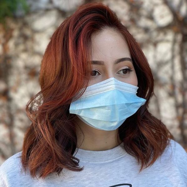Red Brown Dimensional Brunette - a woman wearing mask and light gray shirt.
