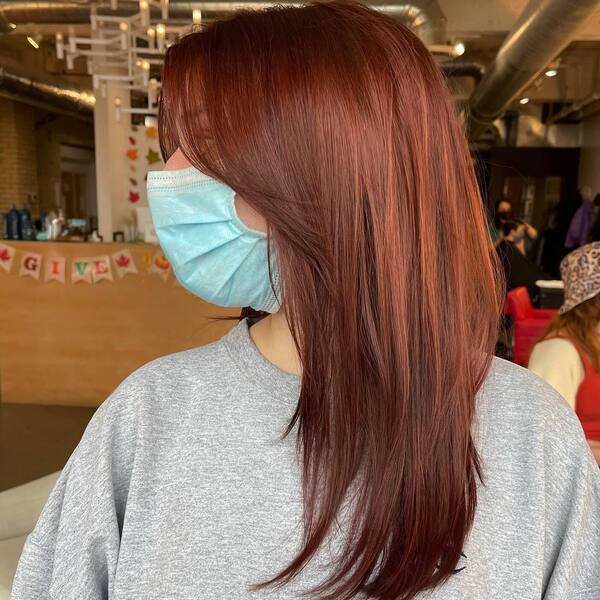 Red Brown Shade in Curtain Hair - a woman wearing light gray long sleeves.