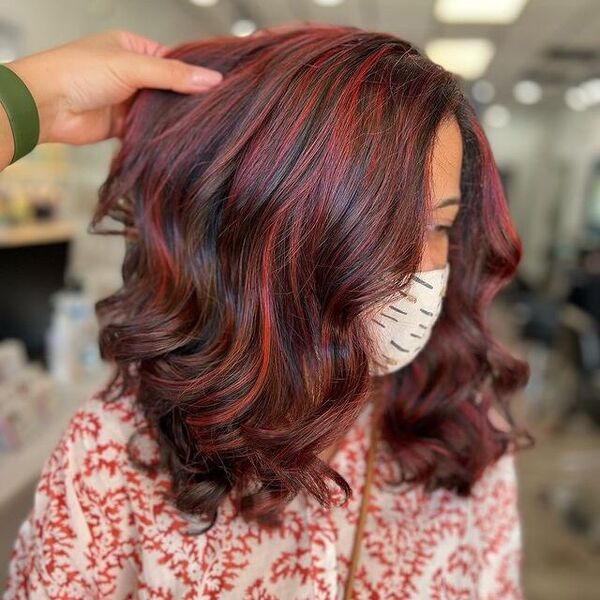 Red Highlights - a woman wearing a printed facemask