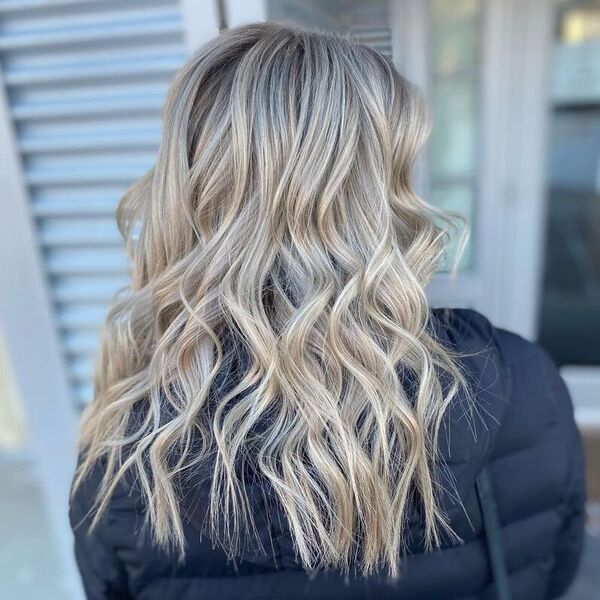 Root Shadow Blonde Balayage - a woman wearing a thick coat