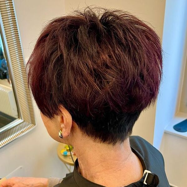 Shag Red Brown Tint on Pixie - a woman wearing loop earrings in black salon cape.