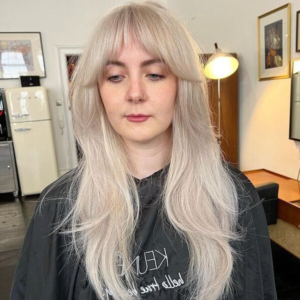 Shaggy White Blonde Hair - a woman wearing a black printed cape