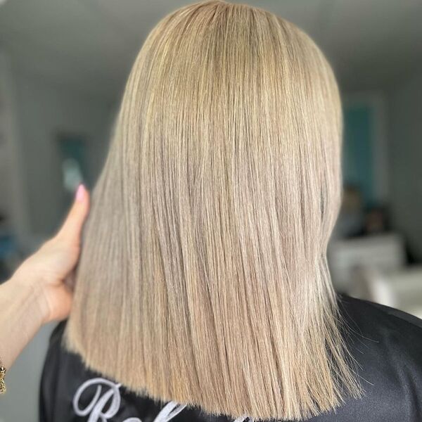 Shoulder Length Hair with Ash Blonde - a woman wearing a black cape