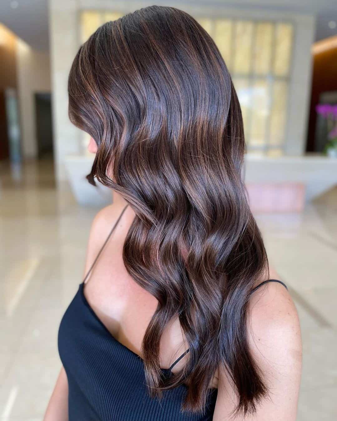 Side Swept Caramel Highlights On Black Hair