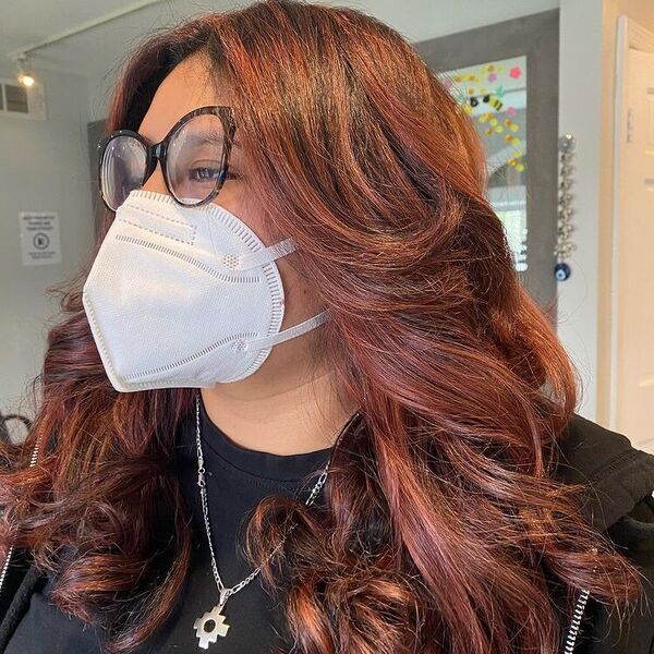 Spicy Red Brown on Blunt Curtain Curls - a woman wearing silver necklace and black shirt.