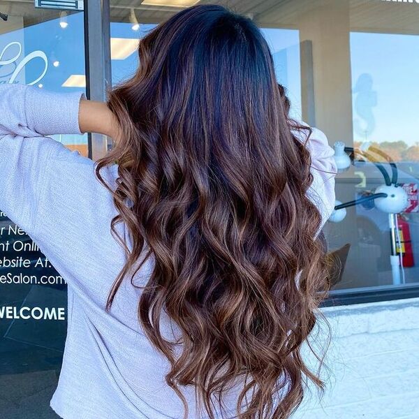 Spring Brunette Balayage - a woman wearing light blue long sleeves.