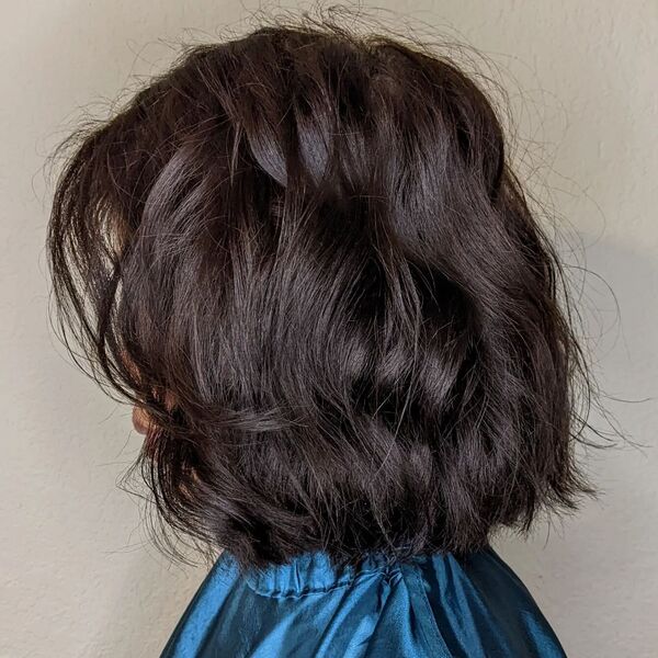 Textured Layered Bob with Subtle Balayage - a woman wearing silk blue salon cape.