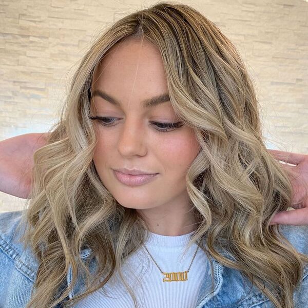 Toasted Oak Blonde Balayage - a woman wearing a denim jacket and a white top