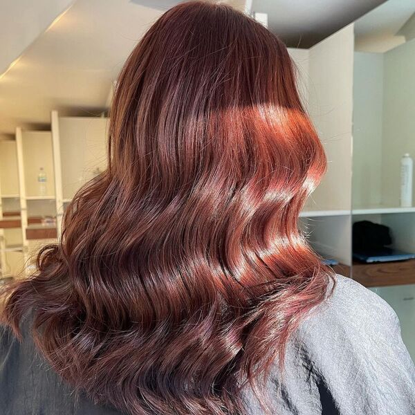 Vibrant Autumn Inspired Hair Tone - a woman wearing black salon cape.