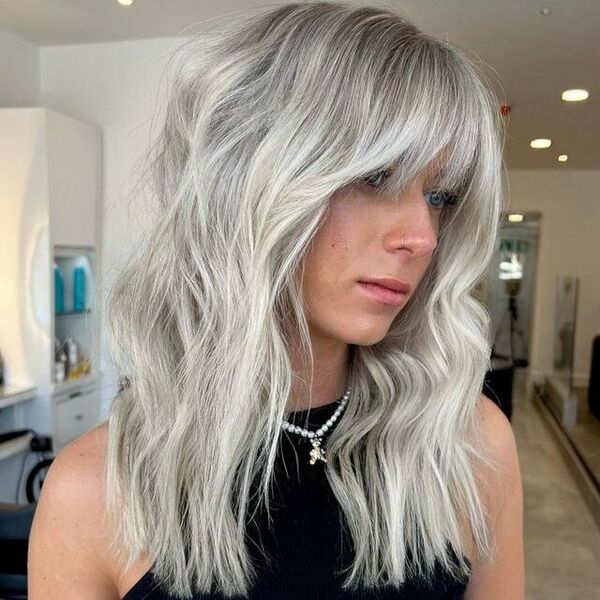 White Blonde Balayage - a woman wearing a black top