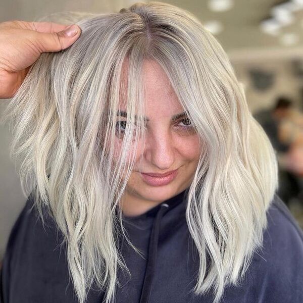 White Gray Blonde Hair - a woman wearing a black jacket