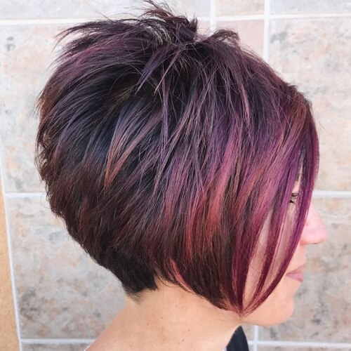 a woman wearing a black blouse has a spiky inverted bob haircut