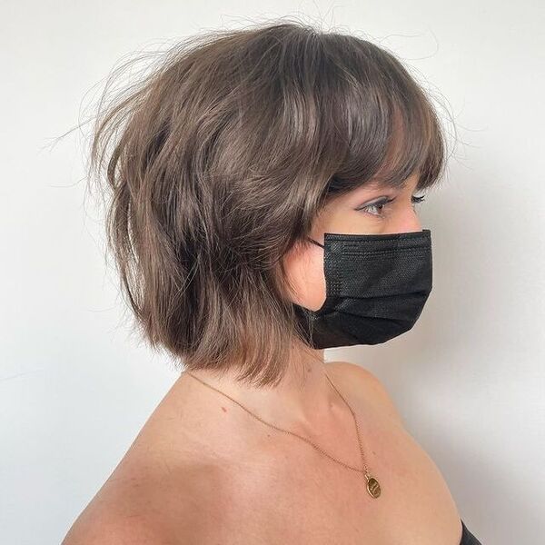 A woman wearing a black facemask