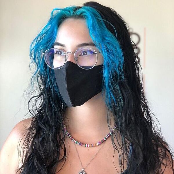 a woman wearing a eyeglasses and black facemask