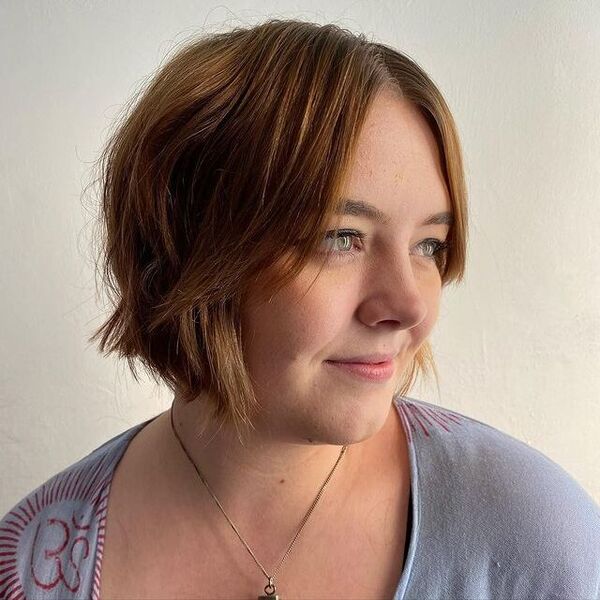 A woman wearing a gray blazer
