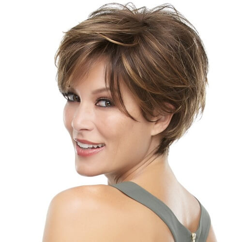a woman wearing a gray sleeveless has a inverted layered bob hairstyle
