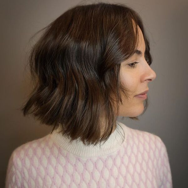 A woman wearing a pink and white longsleeve