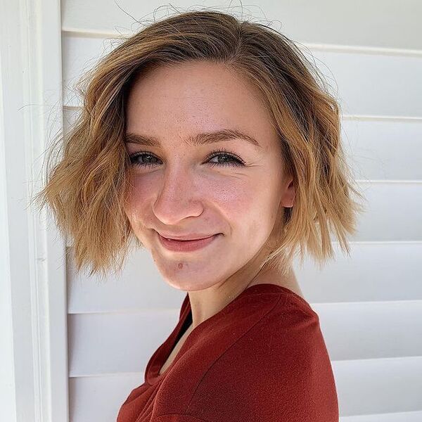 a woman wearing a rust shirt