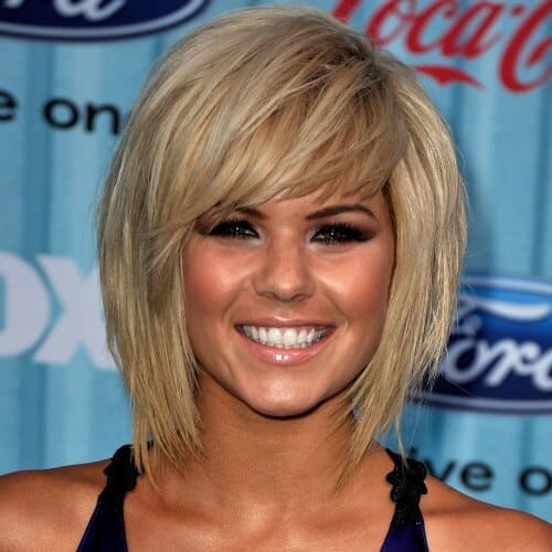 a woman wearing a sleeveless has a inverted bob hair