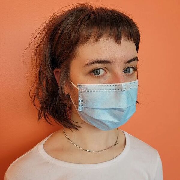 A woman wearing a surgical facemask