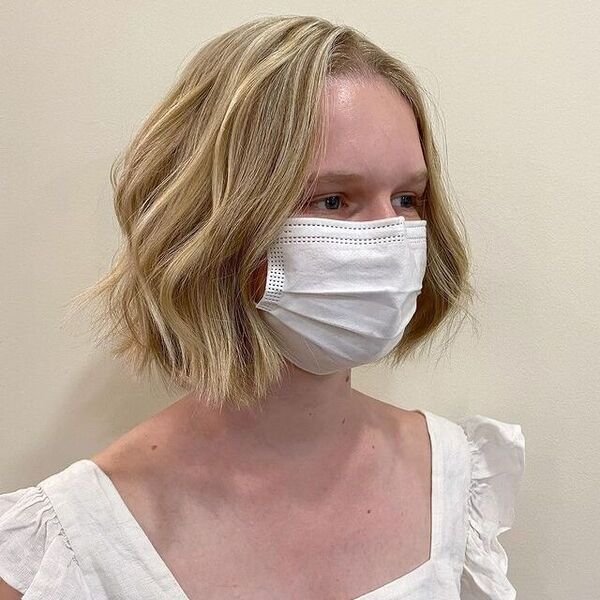 A woman wearing a white facemask