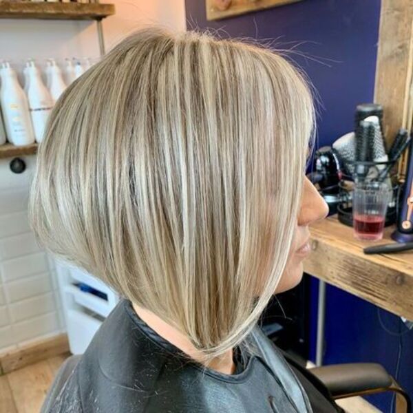 a woman wearing black barbers cape