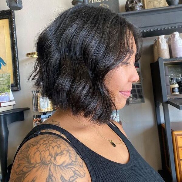 A woman with a tattoo wearing a black sleeveless shirt