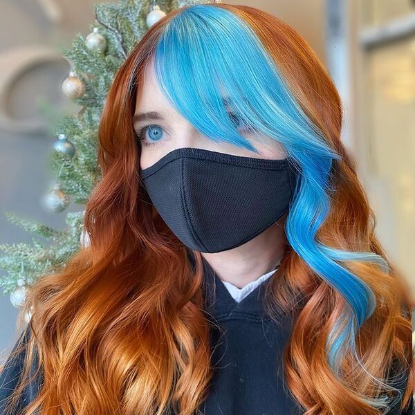 Blonde Hair with Pop of Light Blue - a woman wearing a black facemask