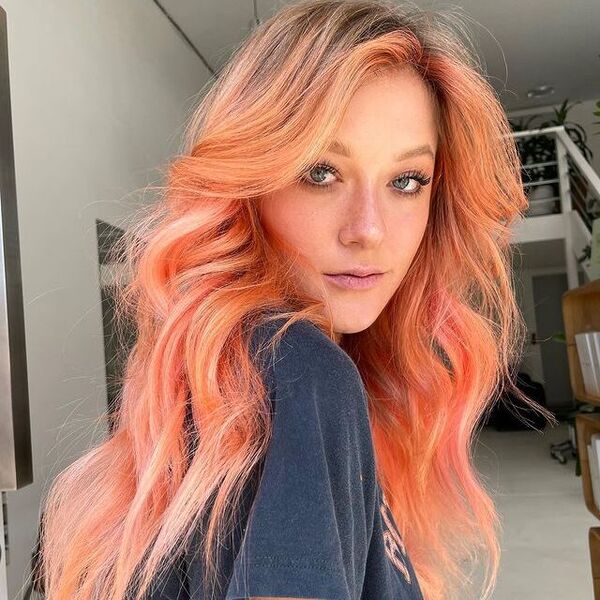 Blonde Peach Balayage - a woman wearing a black shirt