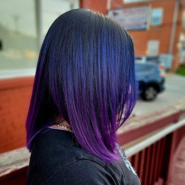 blue and purple hairstyle - a woman wearing a black shirt