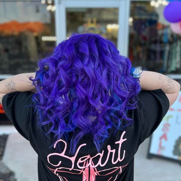 blue and purple hairstyle - a woman wearing a black printed shirt