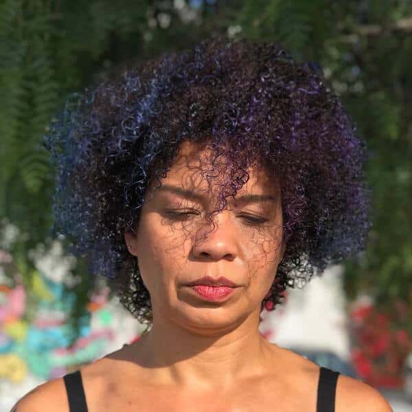 blue and purple hairstyle - a woman wearing a black sleeveless shirt