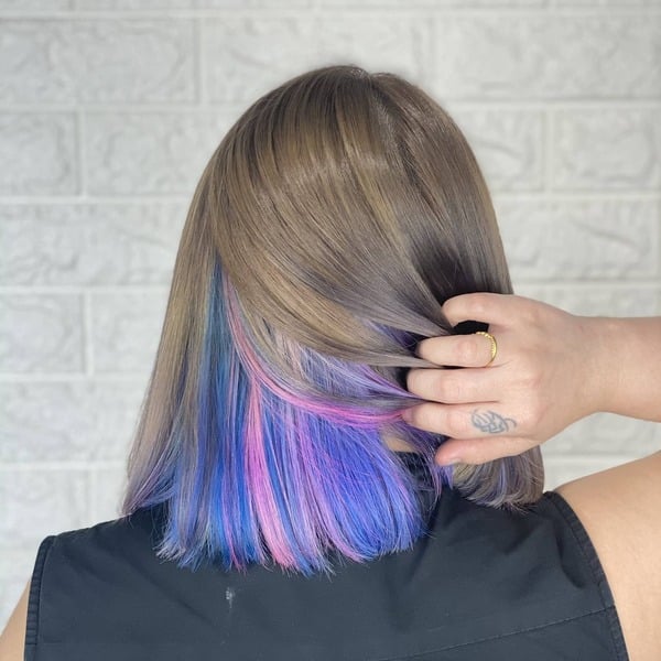 blue and purple hairstyle - a woman wearing a black sleeveless shirt