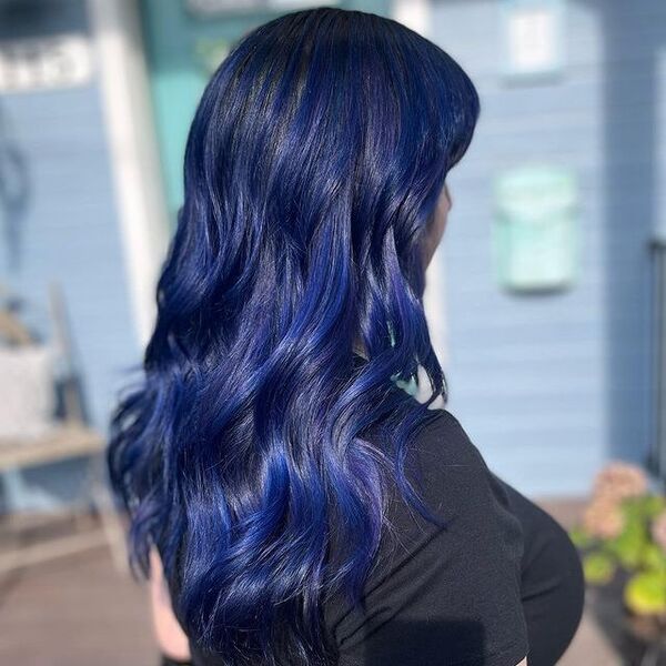 blue and purple hairstyle - a woman wearing a black shirt