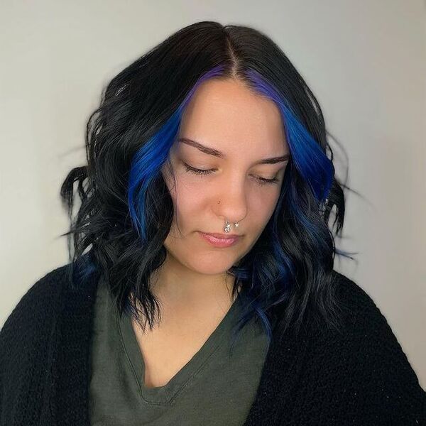 blue and purple hairstyle - a woman wearing a black blazer