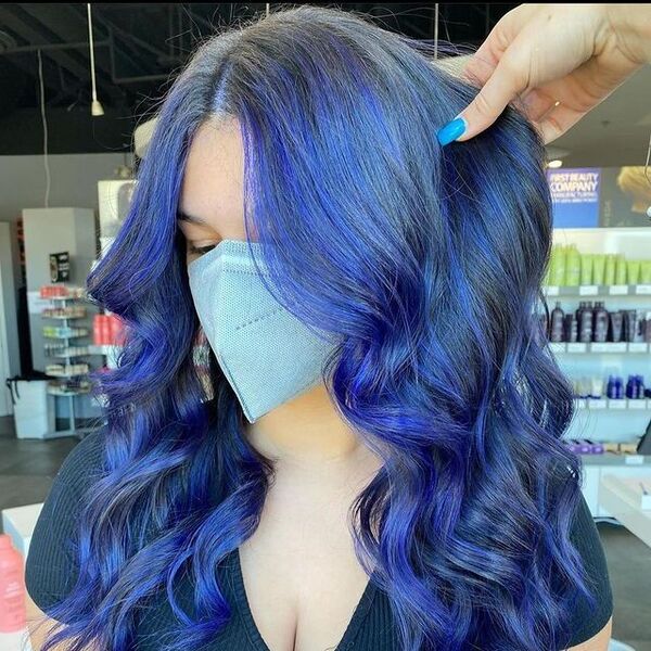 blue and purple hairstyle - a woman wearing a black top