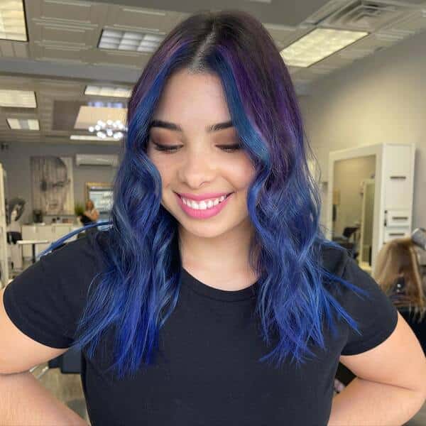 blue and purple hairstyle - a woman wearing a black shirt