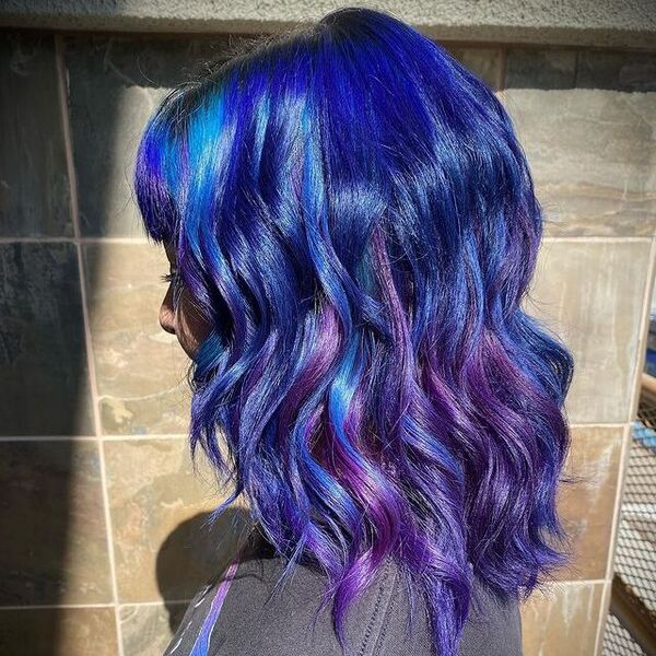 blue and purple hairstyle - a woman wearing a black shirt