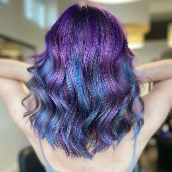 blue and purple hairstyle - a woman wearing a sleeveless top