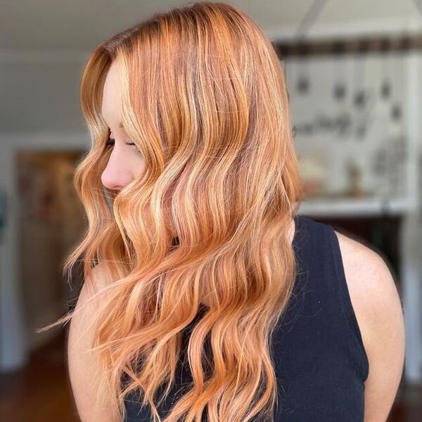 Bubblegum Peach Pink Hairstyle - a woman wearing a black sleeveless shirt