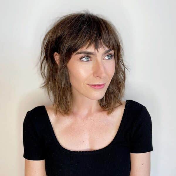 Choppy bob - a woman wearing a black top