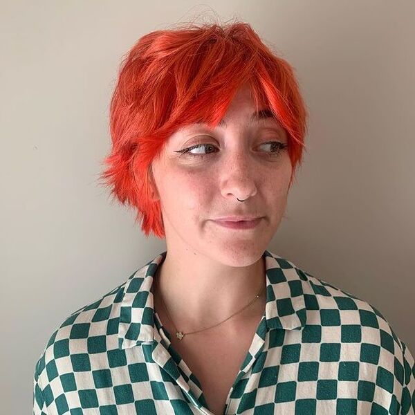 Choppy bob - a woman wearing a green and white polo