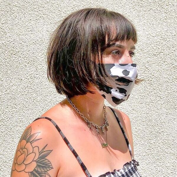Choppy bob - a woman wearing a necklace