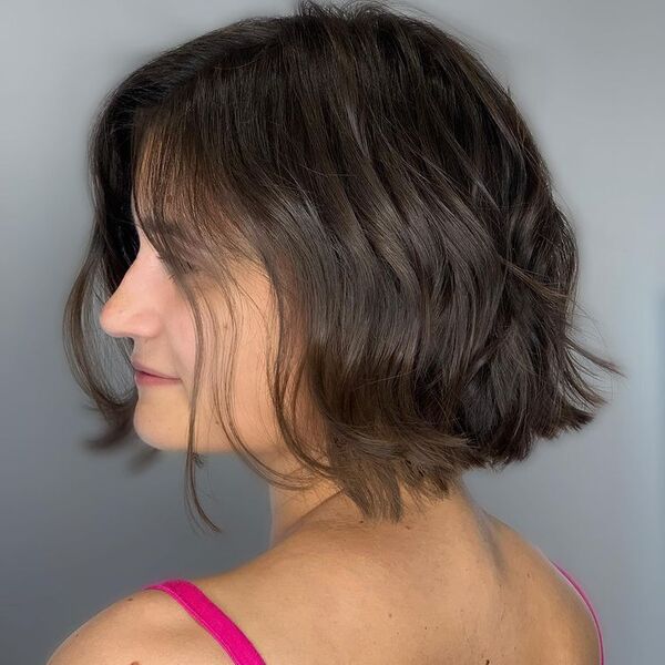 Choppy bob - a woman wearing a pink sleeveless shirt