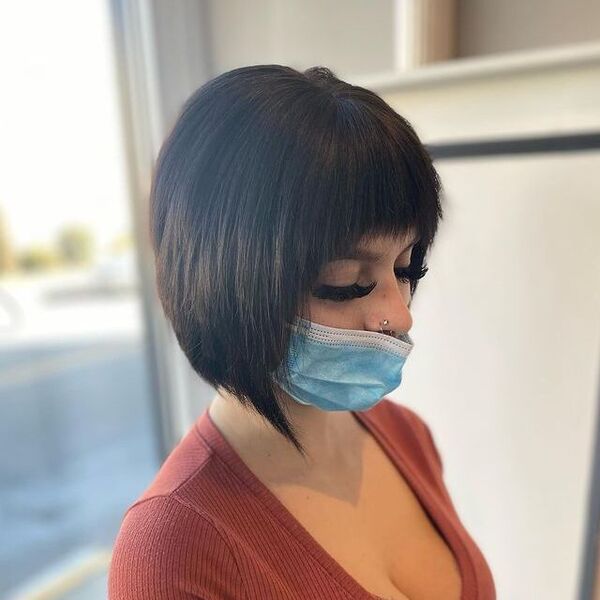 choppy bob - a woman wearing a surgical facemask