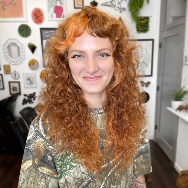 Curly Blonde Hair with Pop of Peach - a woman inside a salon