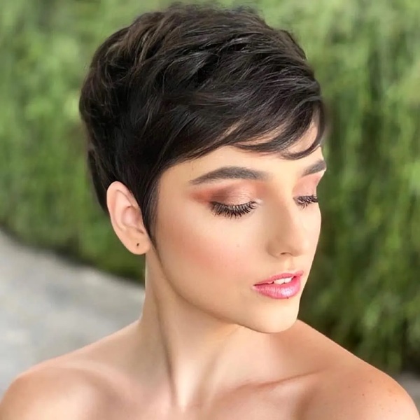 Feathered Side Edgy Pixie - a woman wearing full glam make up