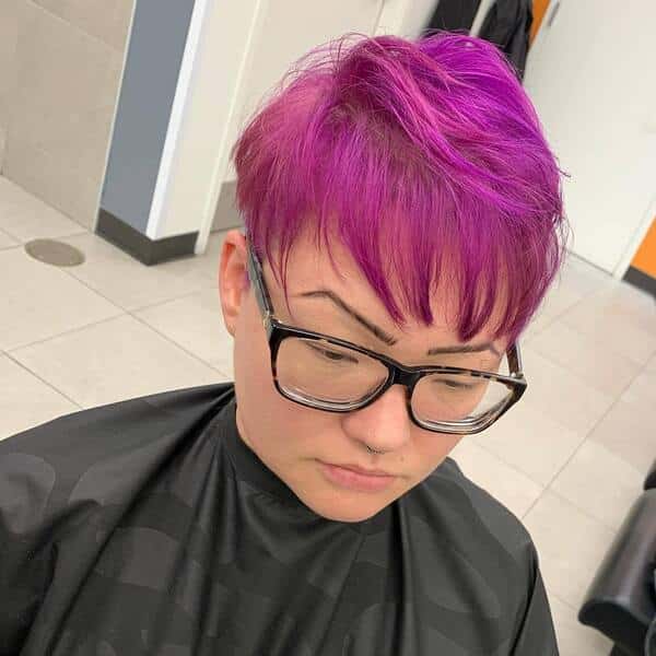 Fine Magenta Edgy Pixie - a woman wearing salon cape