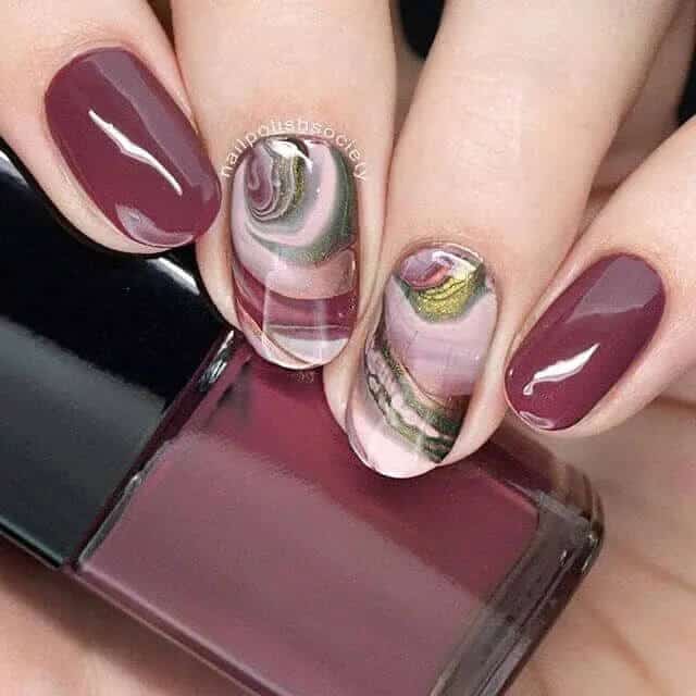 Geode-Inspired Swirls Of Earthy Burgundy Nails